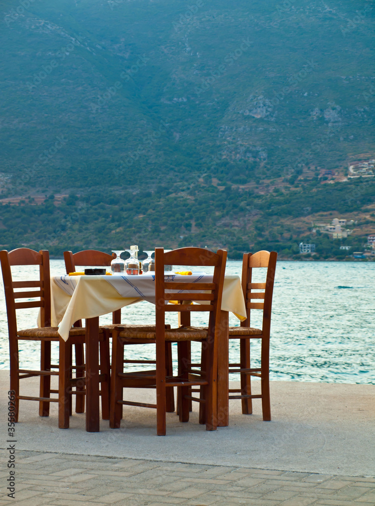 Table prepared for dinner in Vasiliki harbor Greece