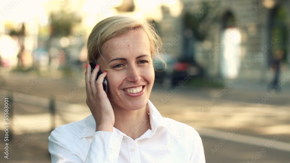 Businesswoman talking on cellphone in the city Businesswoman talking on cellphone in the city