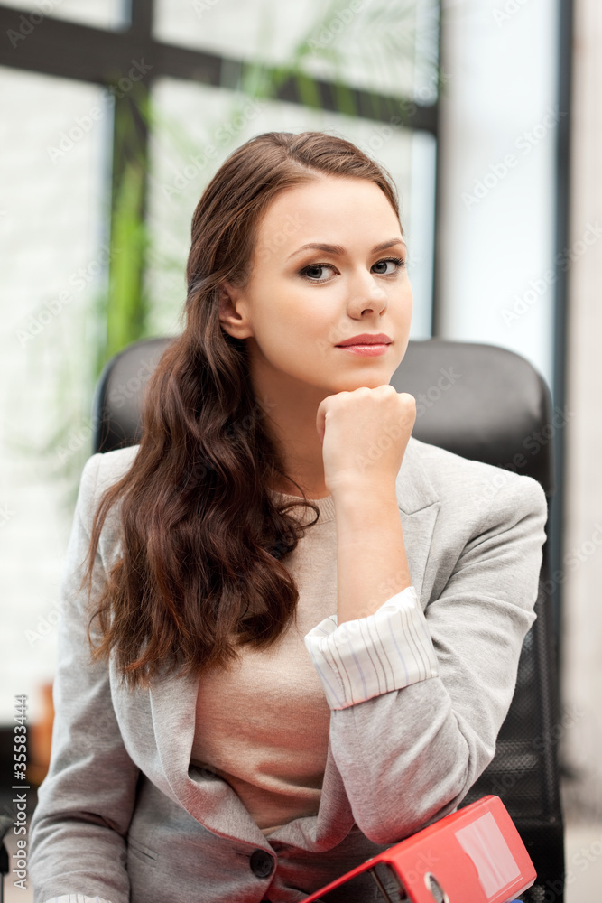 young businesswoman with folders sitting in chair