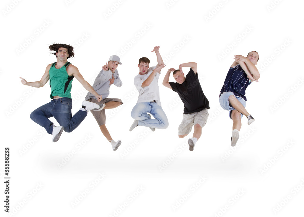 Group of young teenagers jumping over white