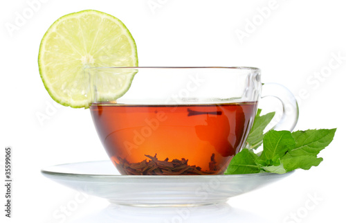 black tea in cup, mint and lime isolated on white