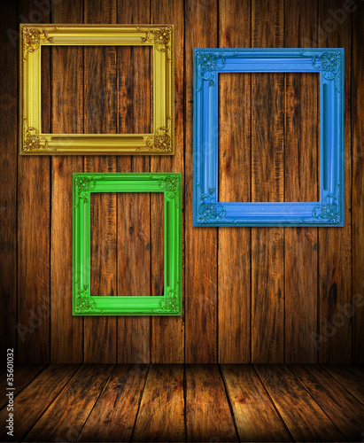 Old antique colorful frame on wood wall