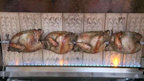 Four chicken are rosting in grill photo