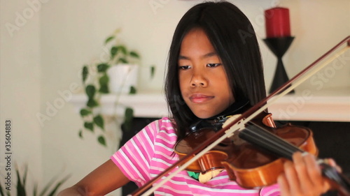 Asian Girl Practicing Violin photo