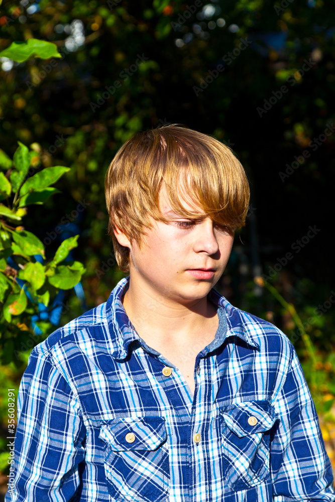portrait of angry boy in leaves portrait of angry boy in leaves