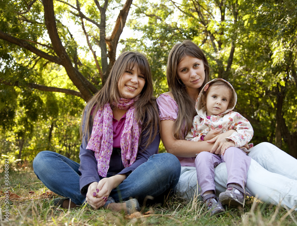Fototapeta premium girlfriends and little child at the park.