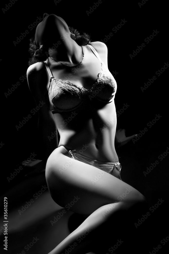Fototapeta premium Sexy woman body in lingerie on black.