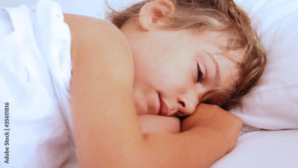 Little girl openes her eyes and awake on pillow Little girl openes her eyes and awake on pillow
