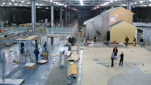 Workers disassemble the exhibition stands