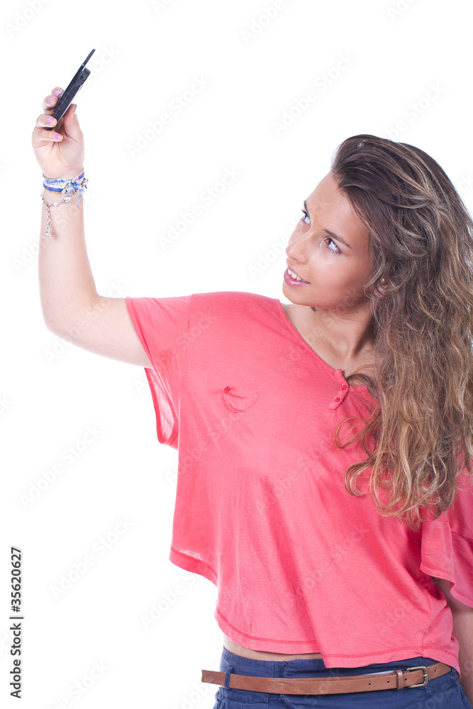 woman is taking pictures of herself with the mobile phone woman is taking pictures of herself with the mobile phone