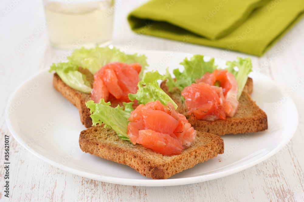 toasts with salmon on a plate