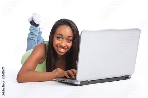 Cute African teenager girl using laptop