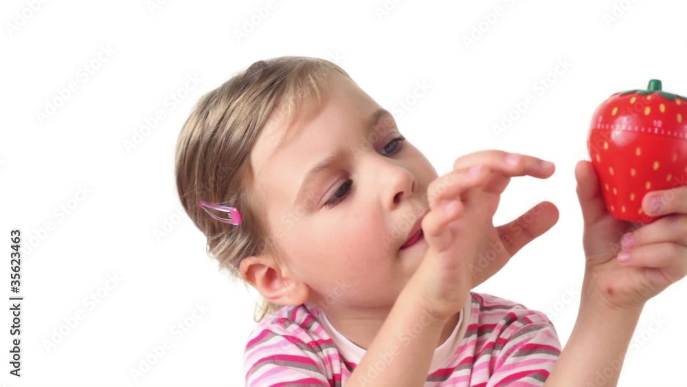 Girl holding timer in the form of strawberries Girl holding timer in the form of strawberries