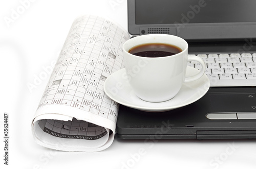 A cup of coffee on a laptop