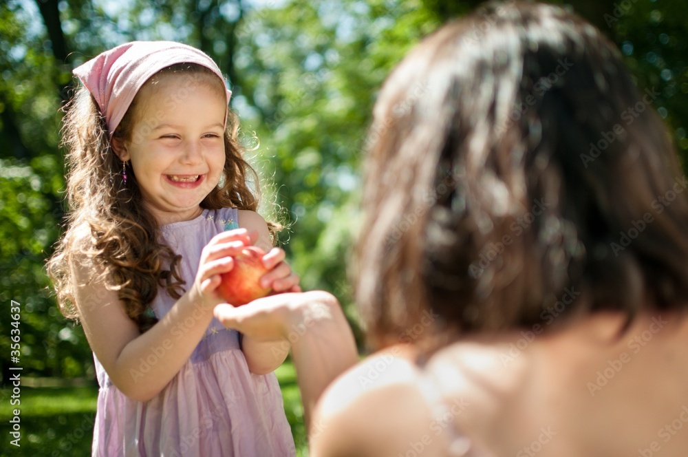 Offering apple - mother with child
