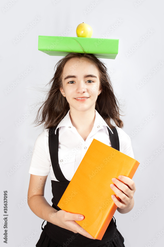 © Natalya Antoshchenko - schoolgirl, an apple and books