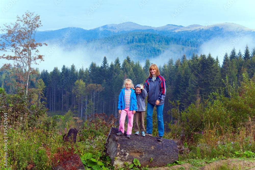 Family on september Carpathian mountain hill