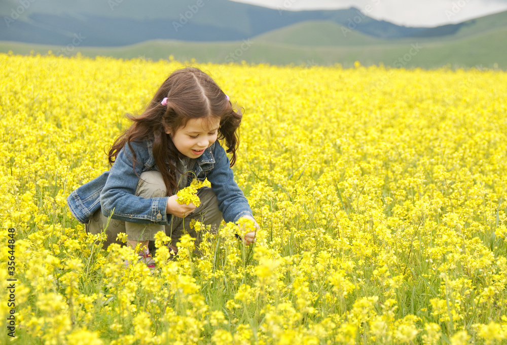 Girl playing among field of flowers Girl playing among field of flowers