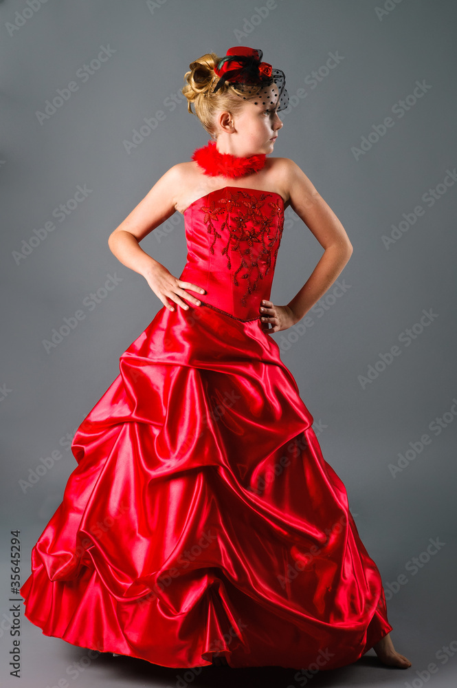 teen girl posing in prom dress on studio neutral background