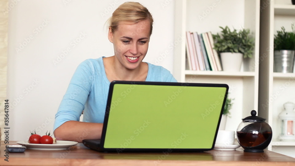 woman eating breakfast and working on laptop, dolly shot woman eating breakfast and working on laptop, dolly shot