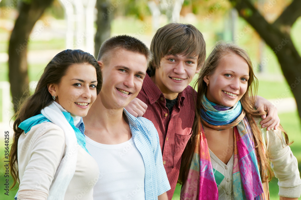 Group of smiling young students outdoors Group of smiling young students outdoors