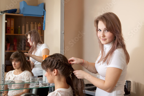 hair stylist working with girl