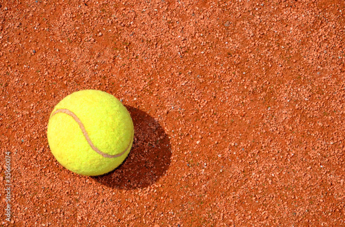 Tennis ball on a tennis clay court © vencav