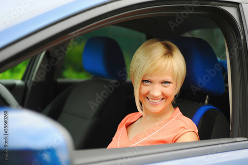 smiling young woman in the car
