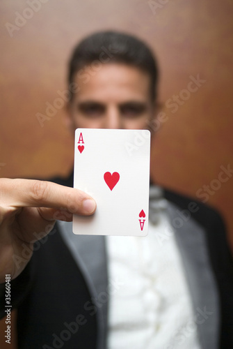 Magician performing with card