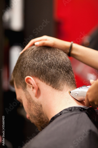 Portrait of a male young student having a haircut