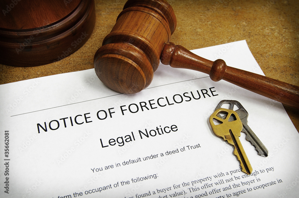 Foreclosure document with house keys and gavel Foreclosure document with house keys and gavel