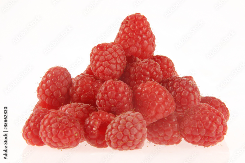 Tasty rasberries in a heap on a white background. Tasty rasberries in a heap on a white background.