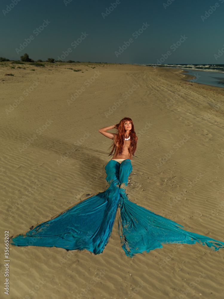 .beautiful red hair mermaid on deserted beach .beautiful red hair mermaid on deserted beach