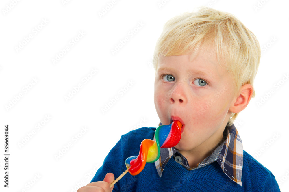 Portrait of a blond little boy eating a lolly Portrait of a blond little boy eating a lolly