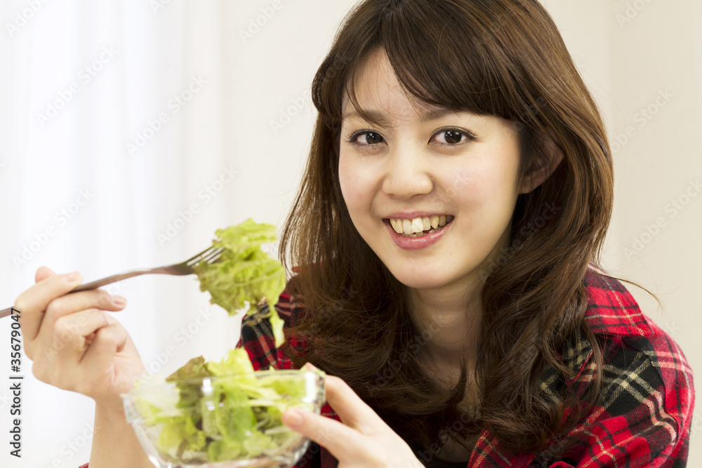 Beautiful asian woman eating salads