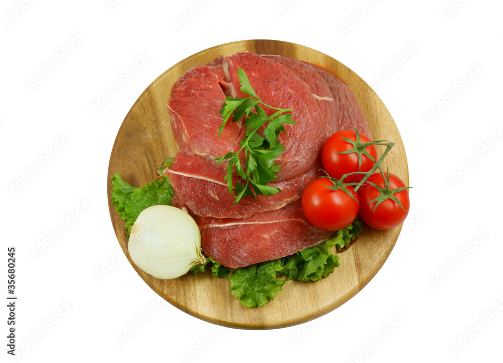 Raw beef meat with fresh vegetables on cutting board Raw beef meat with fresh vegetables on cutting board