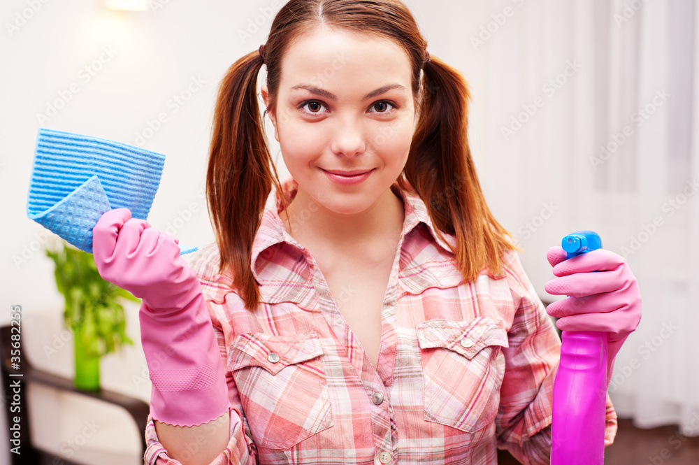 smiley woman with cleansers at home smiley woman with cleansers at home