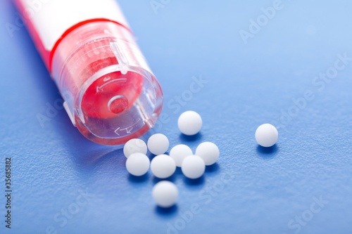 Modern homeopathic pills and container