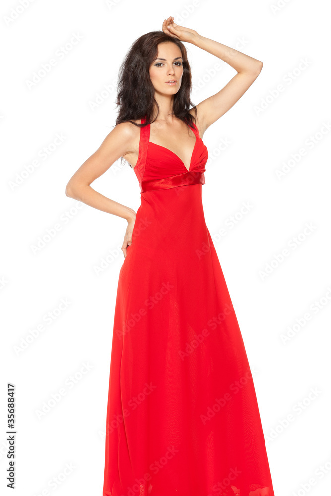Beautiful female fashion model posing in long red dress