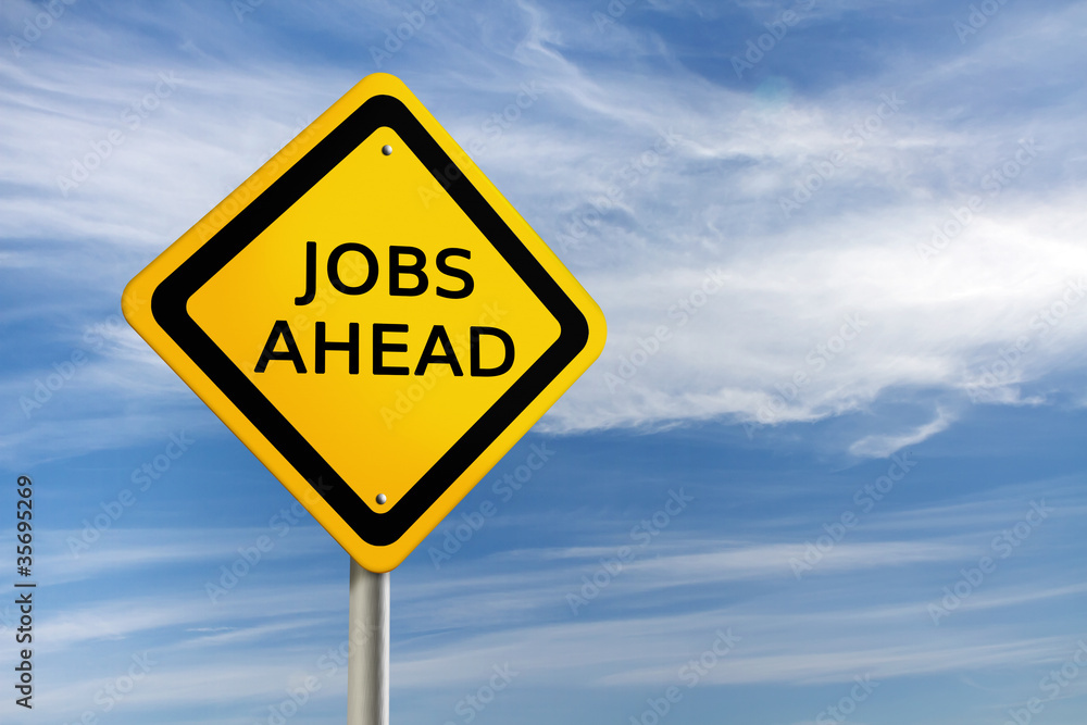 JOBS AHEAD road sign against blue sky JOBS AHEAD road sign against blue sky