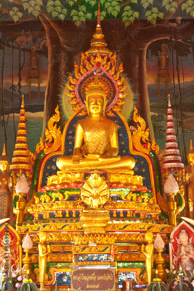Golden buddha statue inside a temple in Ubonratchathani, Thailan