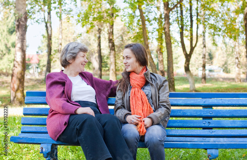 elderly women with girl in autumn park