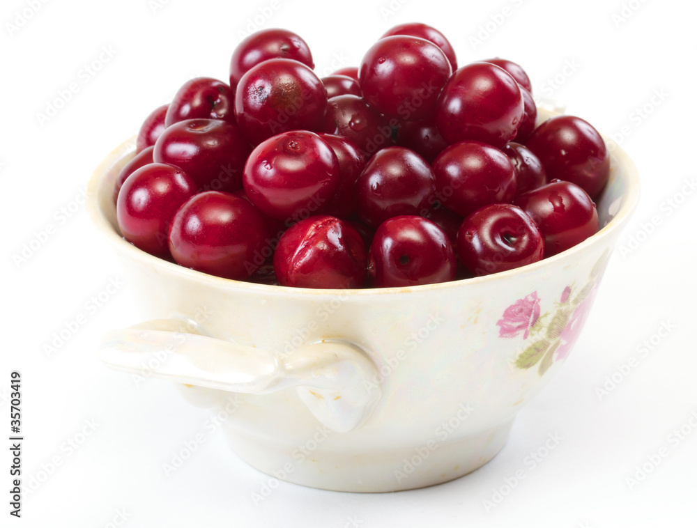 Bowl with ripe cherries. Isolated on a white background. Bowl with ripe cherries. Isolated on a white background.