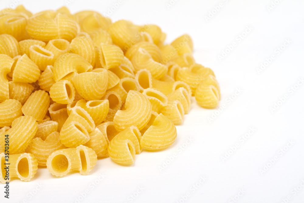 close up of a dried italian pasta on white background close up of a dried italian pasta on white background