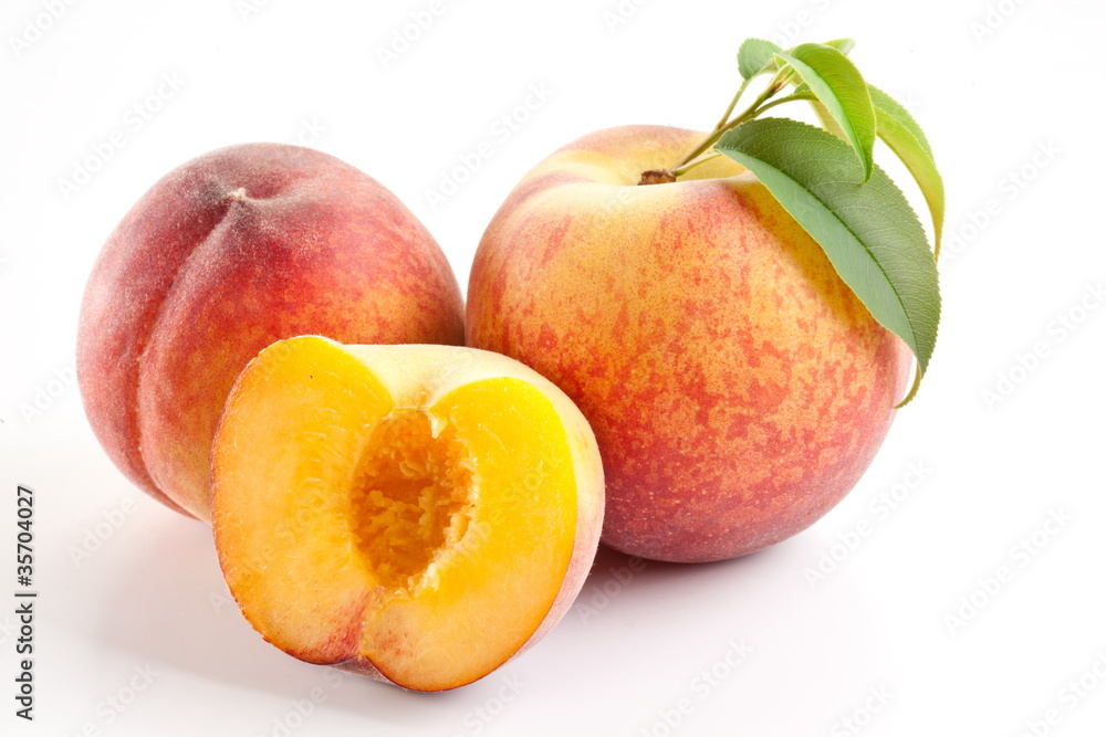 Ripe peach fruit with leaves and slises Ripe peach fruit with leaves and slises