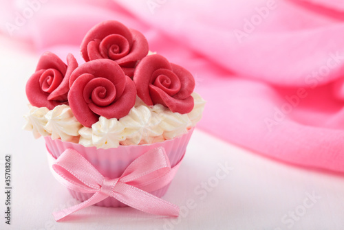 Cup cake with red marzipan roses photo