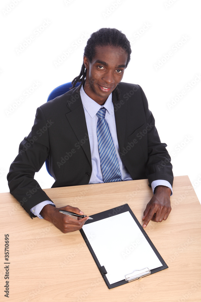 Young African American businessman at office desk Young African American businessman at office desk