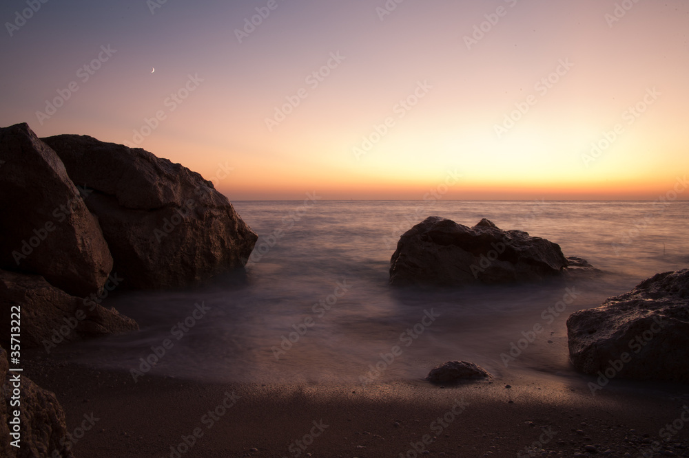 Sun set and rocks at sea