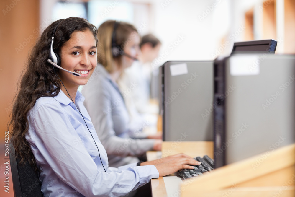 Smiling assistant working with a computer Smiling assistant working with a computer