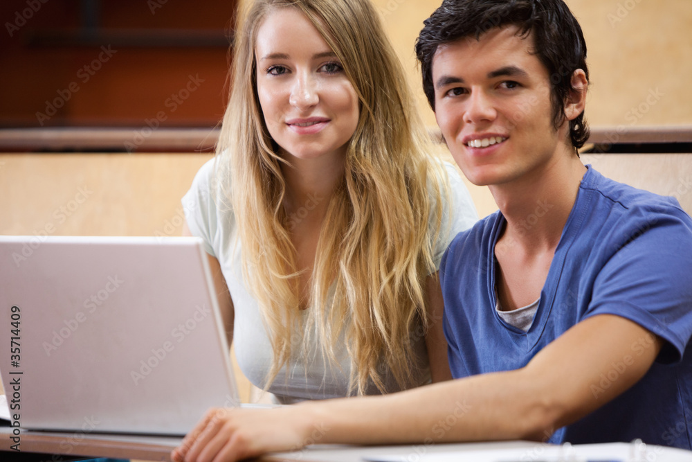 Young students posing with a laptop Young students posing with a laptop